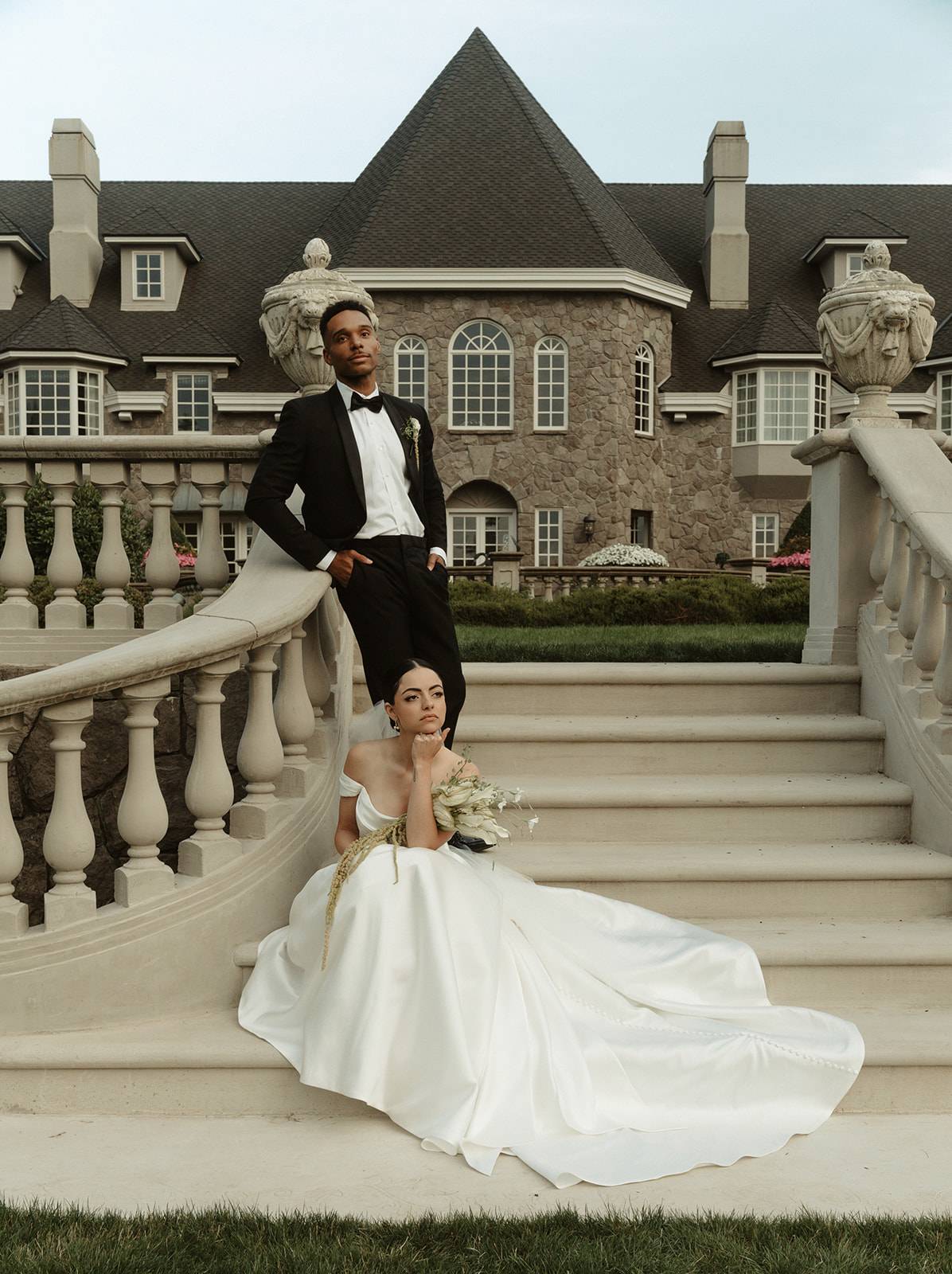 Bride and groom posing on the outside stairs at Chateau de Michellia