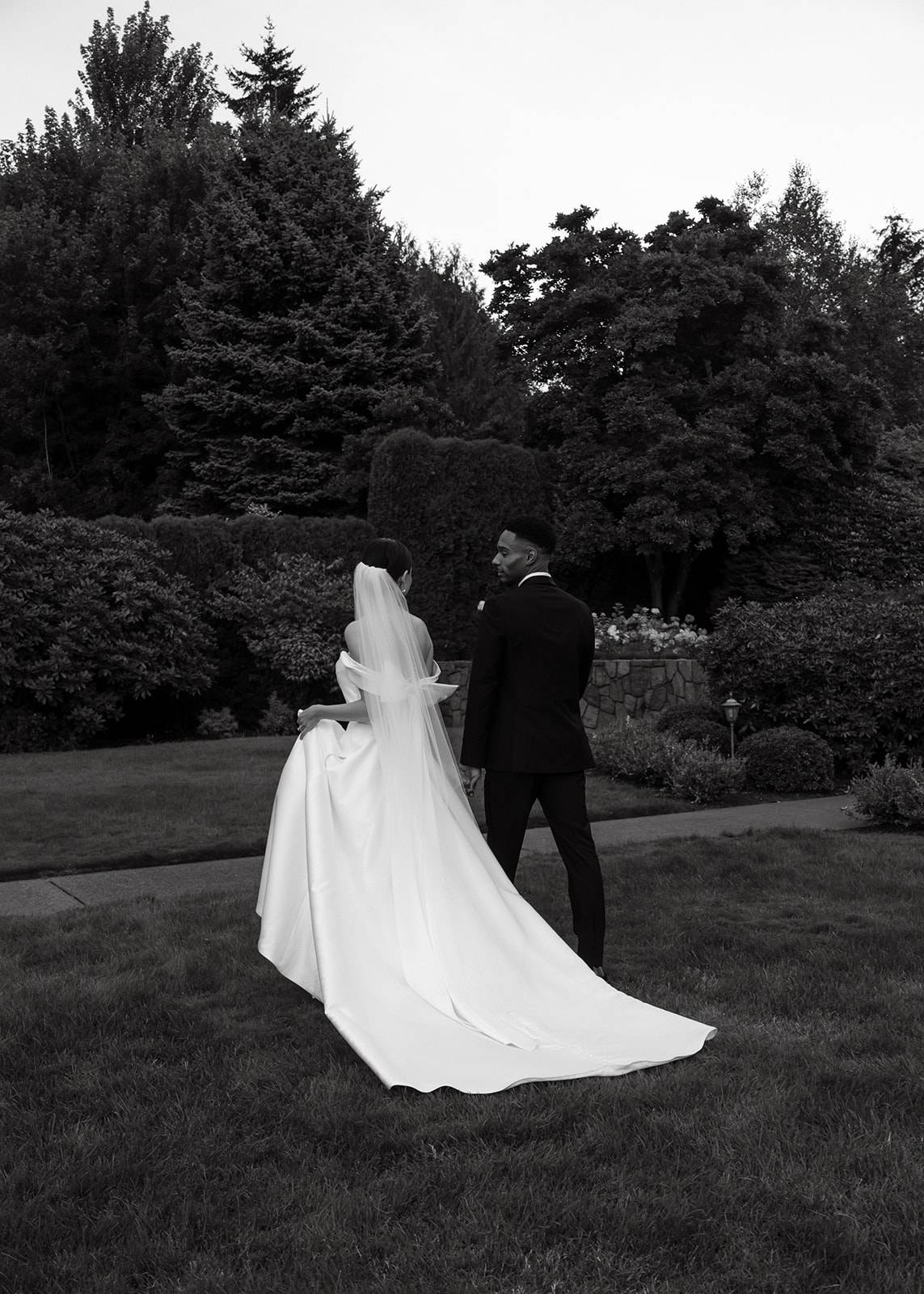 Bride and groom walking off into the gardens